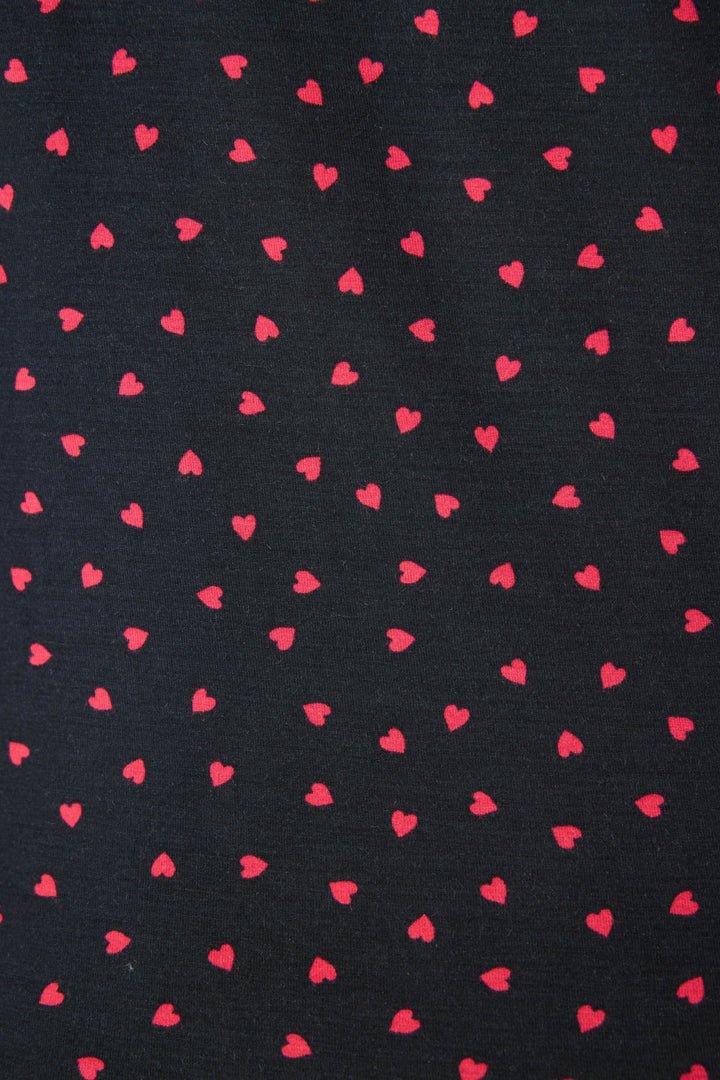 Women's black collared pj short sleeve with pj shorts with pink heart pattern.