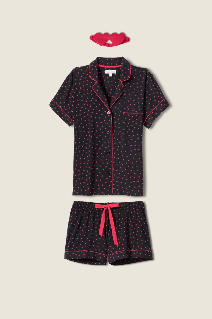 Women's black collared pj short sleeve with pj shorts with pink heart pattern.