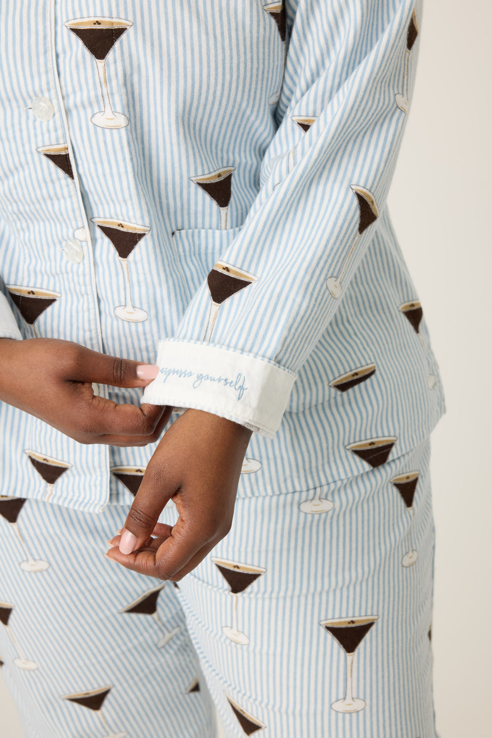 Women's white and blue stripe collared pj long sleeve with tie waist pant with espresso martini pattern.
