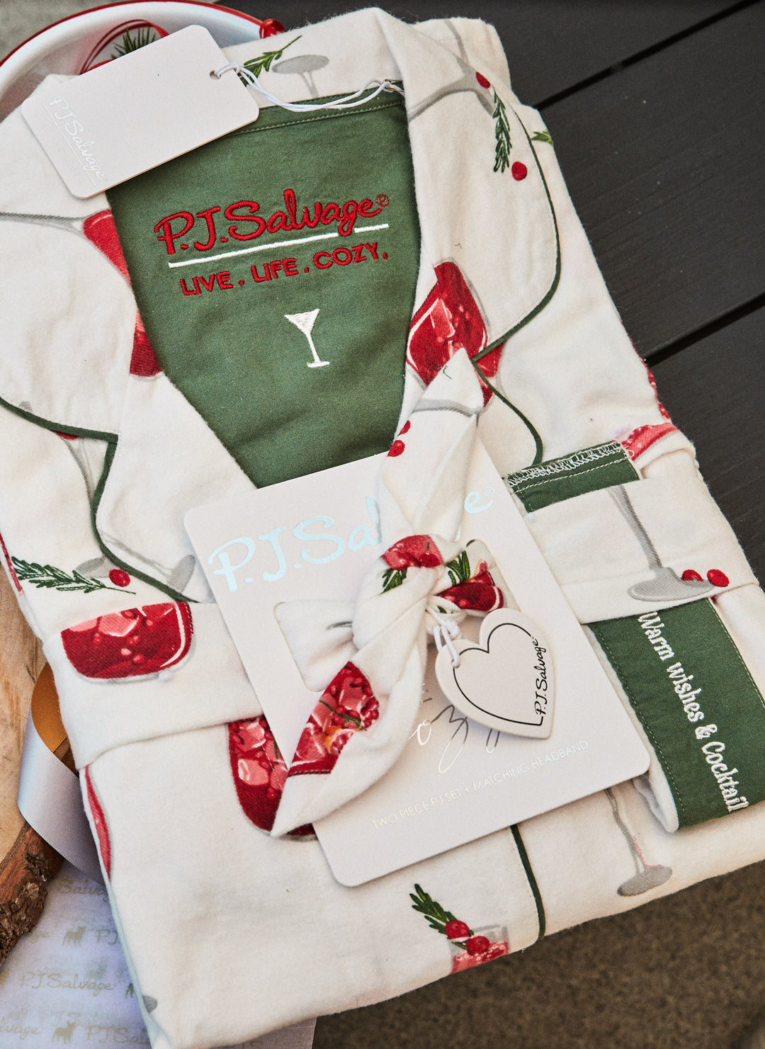 Women's cotton flannel pajama set in ivory & festive red cocktail print. Button-front collared top & tie-waist pant. Embroidered sleeve cuff "Warm Wishes & Cocktail Kisses". Includes matching hair wrap.