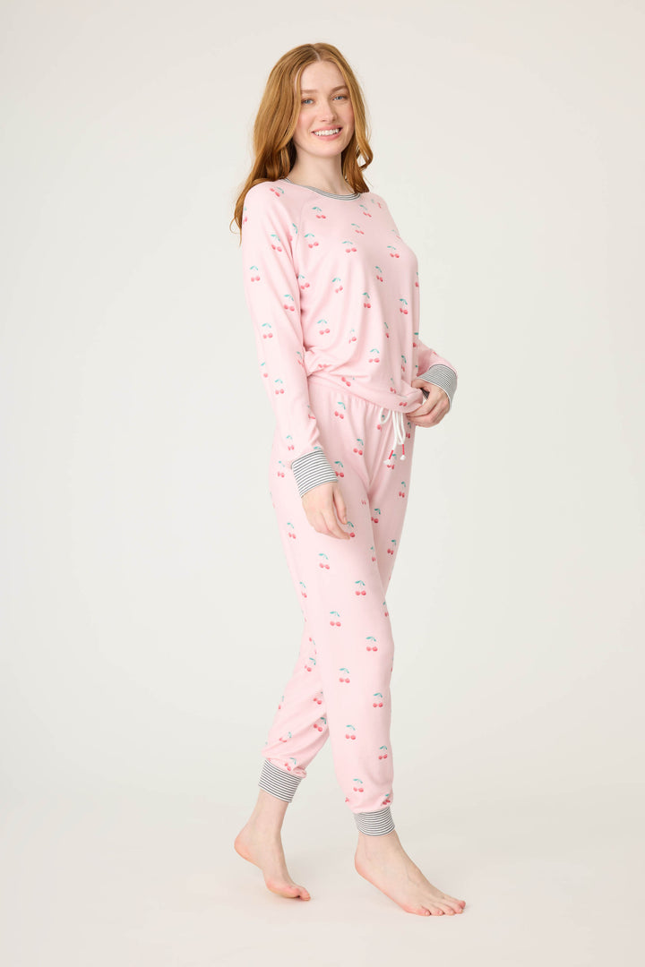 Women's pink jammie top and banded pj pant with cherry pattern.