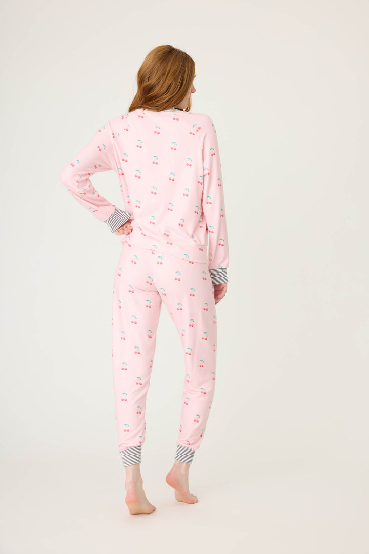 Women's pink jammie top and banded pj pant with cherry pattern.