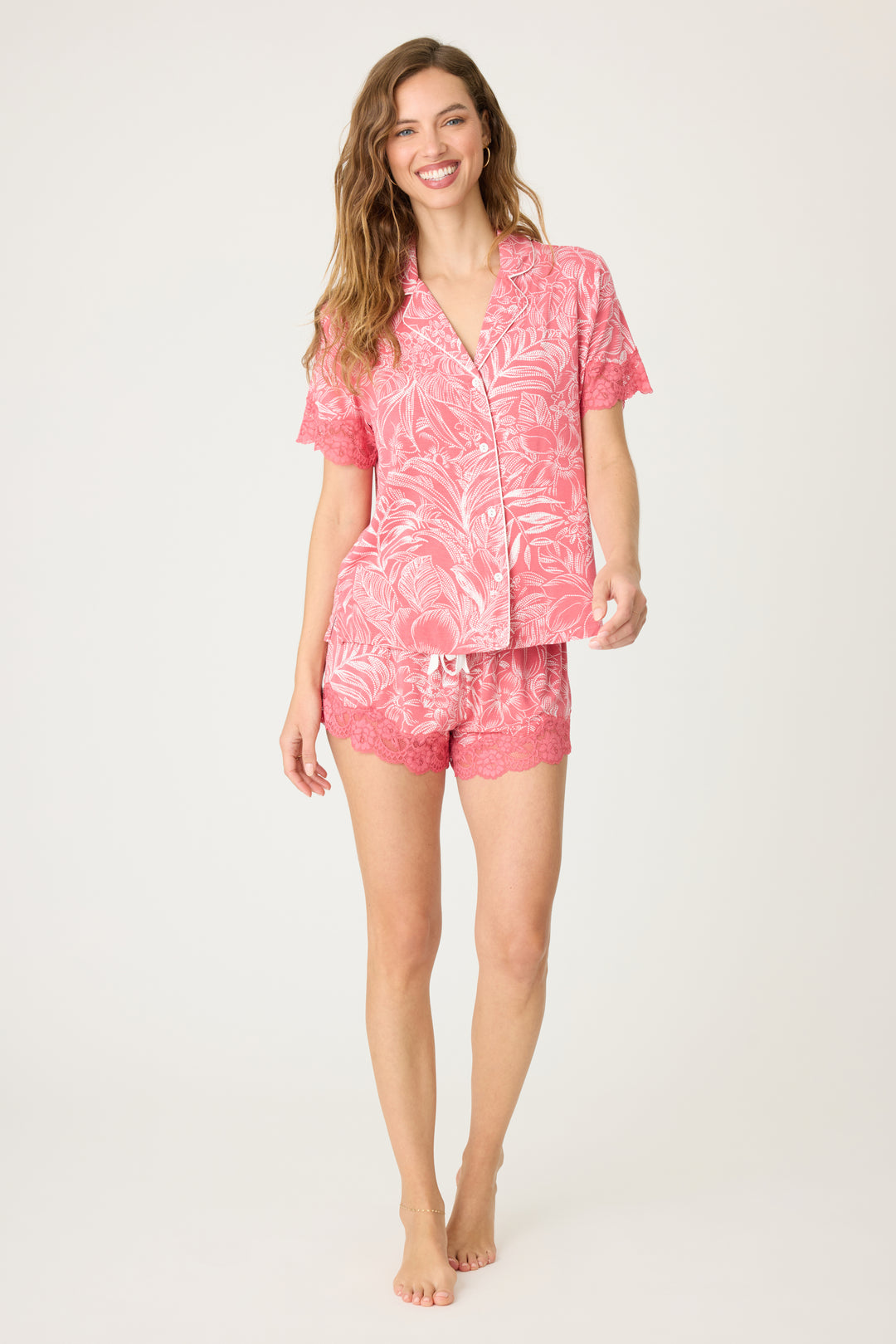 Pink floral modal women's pajama short set with scallop lace hem. Short sleeve button-front top with lace-trim sleeves. Contrast tie waistband.