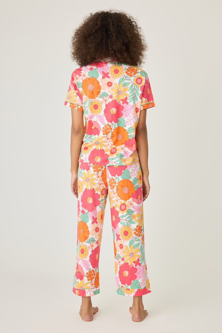 Women's breathable cotton-modal jersey short sleeve pajama set in coral-orange yellow floral print. With aqua contrast piping & tie. Button-front top & open leg pant.