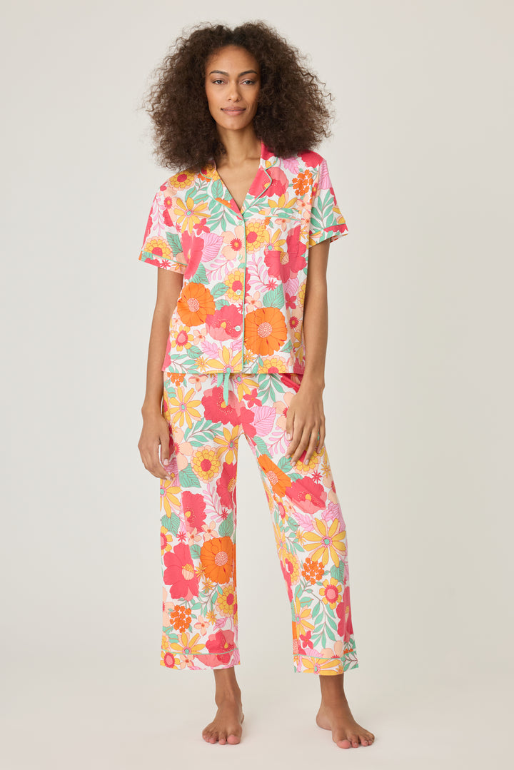 Women's breathable cotton-modal jersey short sleeve pajama set in coral-orange yellow floral print. With aqua contrast piping & tie. Button-front top & open leg pant.