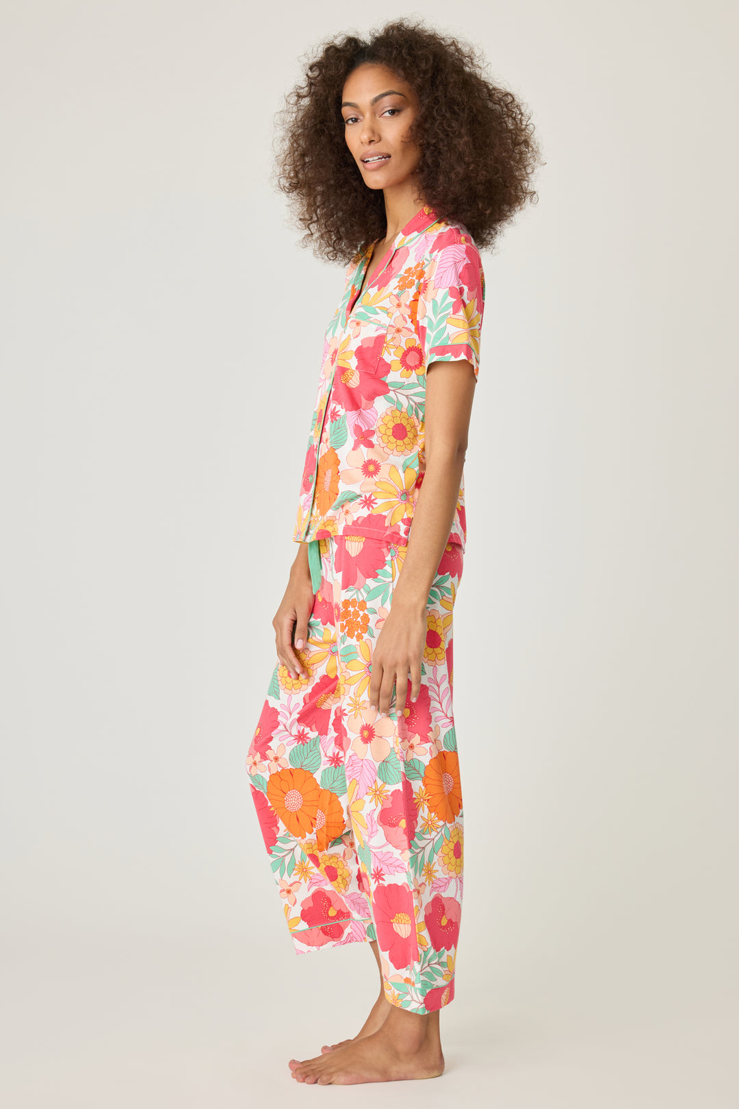 Women's breathable cotton-modal jersey short sleeve pajama set in coral-orange yellow floral print. With aqua contrast piping & tie. Button-front top & open leg pant.