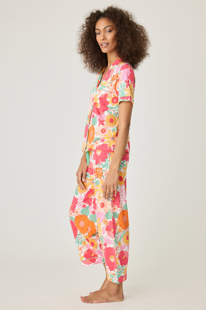 Women's breathable cotton-modal jersey short sleeve pajama set in coral-orange yellow floral print. With aqua contrast piping & tie. Button-front top & open leg pant.