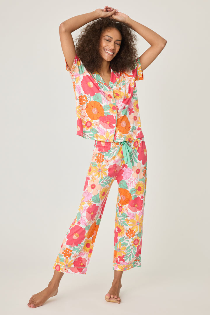 Women's breathable cotton-modal jersey short sleeve pajama set in coral-orange yellow floral print. With aqua contrast piping & tie. Button-front top & open leg pant.