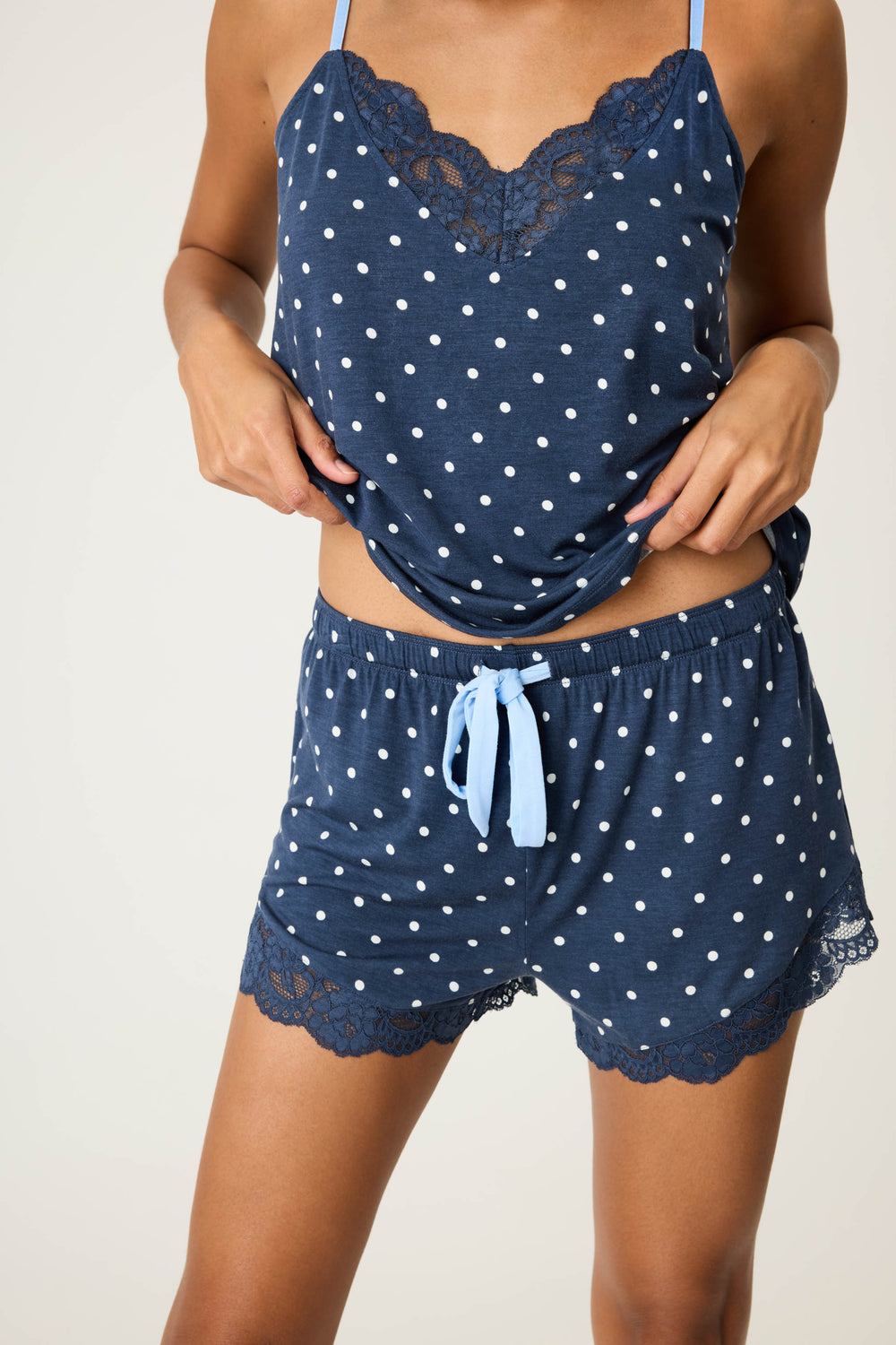 Women's navy blue w/ivory polka dot camisole & short sleep set in modal jersey. Cami has adjustable straps & lace inset neckline. Short has contrast tie-waist & lace hem.