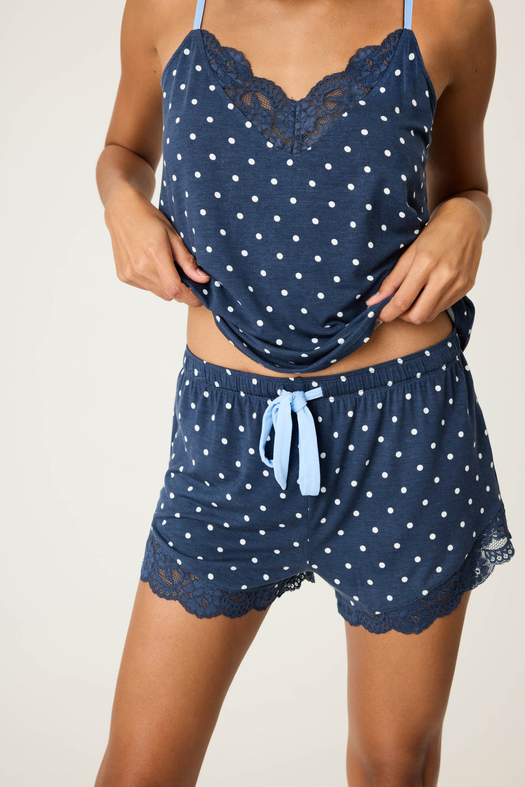 Women's navy blue w/ivory polka dot camisole & short sleep set in modal jersey. Cami has adjustable straps & lace inset neckline. Short has contrast tie-waist & lace hem.