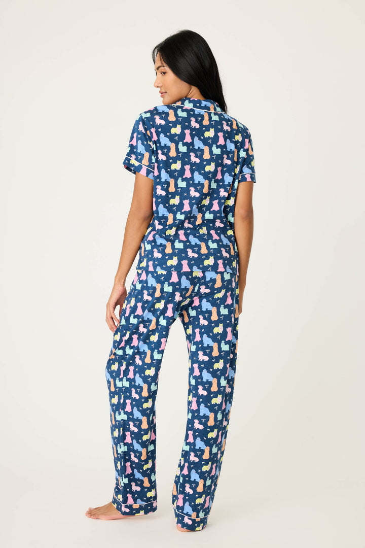 Women's breathable cotton-modal jersey short sleeve pajama set in navy w/pastel dog print with contrast ivory piping. Button-front top & open leg tie-waist pant.