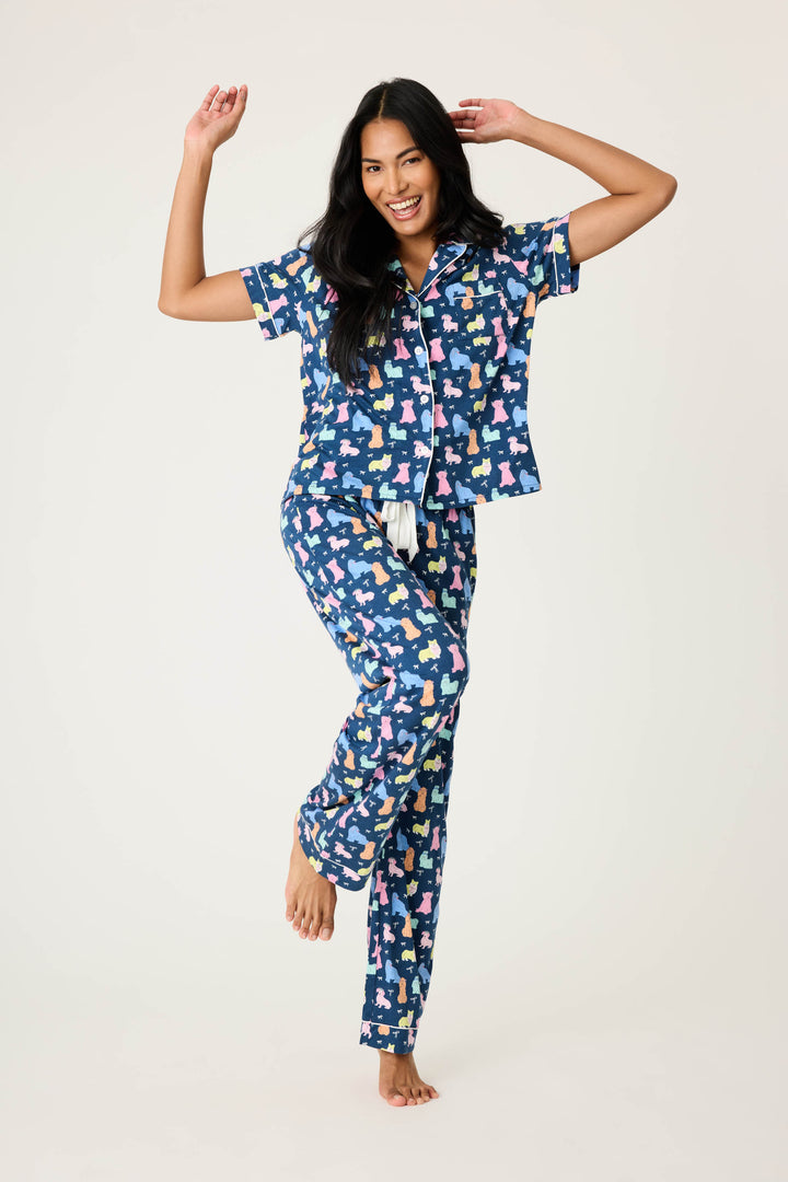 Women's breathable cotton-modal jersey short sleeve pajama set in navy w/pastel dog print with contrast ivory piping. Button-front top & open leg tie-waist pant.