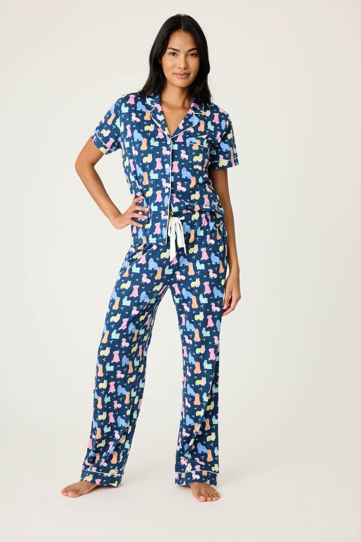 Women's breathable cotton-modal jersey short sleeve pajama set in navy w/pastel dog print with contrast ivory piping. Button-front top & open leg tie-waist pant.