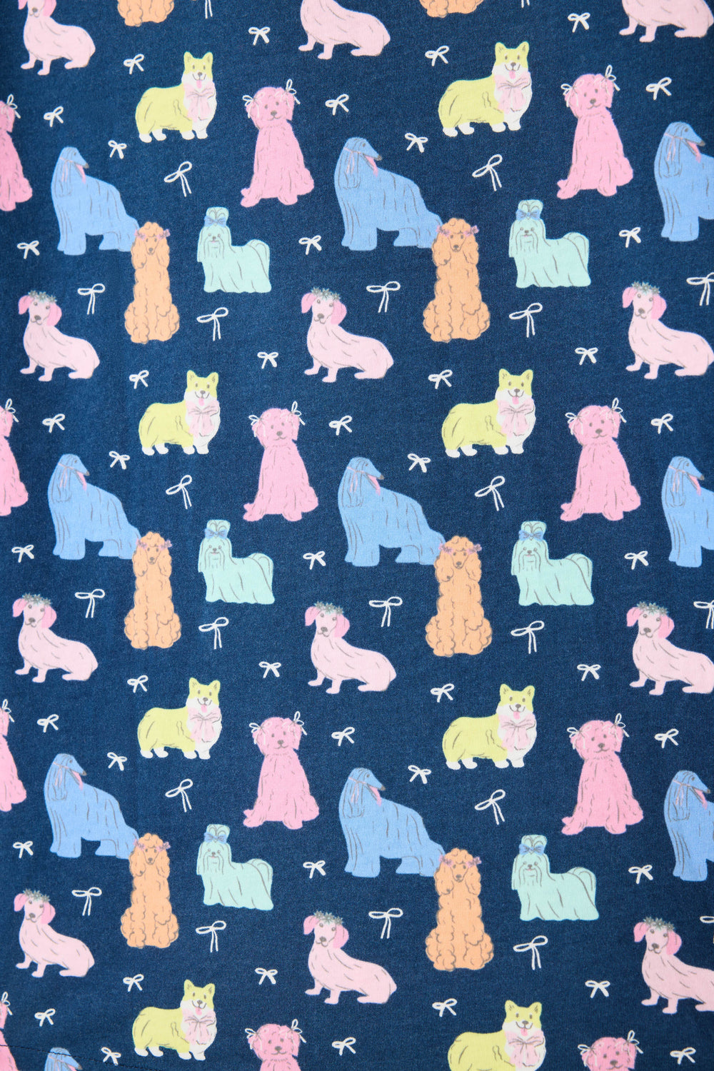 Women's breathable cotton-modal jersey short sleeve pajama set in navy w/pastel dog print with contrast ivory piping. Button-front top & open leg tie-waist pant.