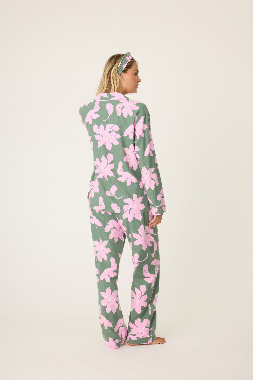 Women's cotton flannel pajama set in green & pink poinsettia print. Button-front collared top & tie-waist pant. Embroidered sleeve cuff "Find Peace Within". Includes matching hair wrap.