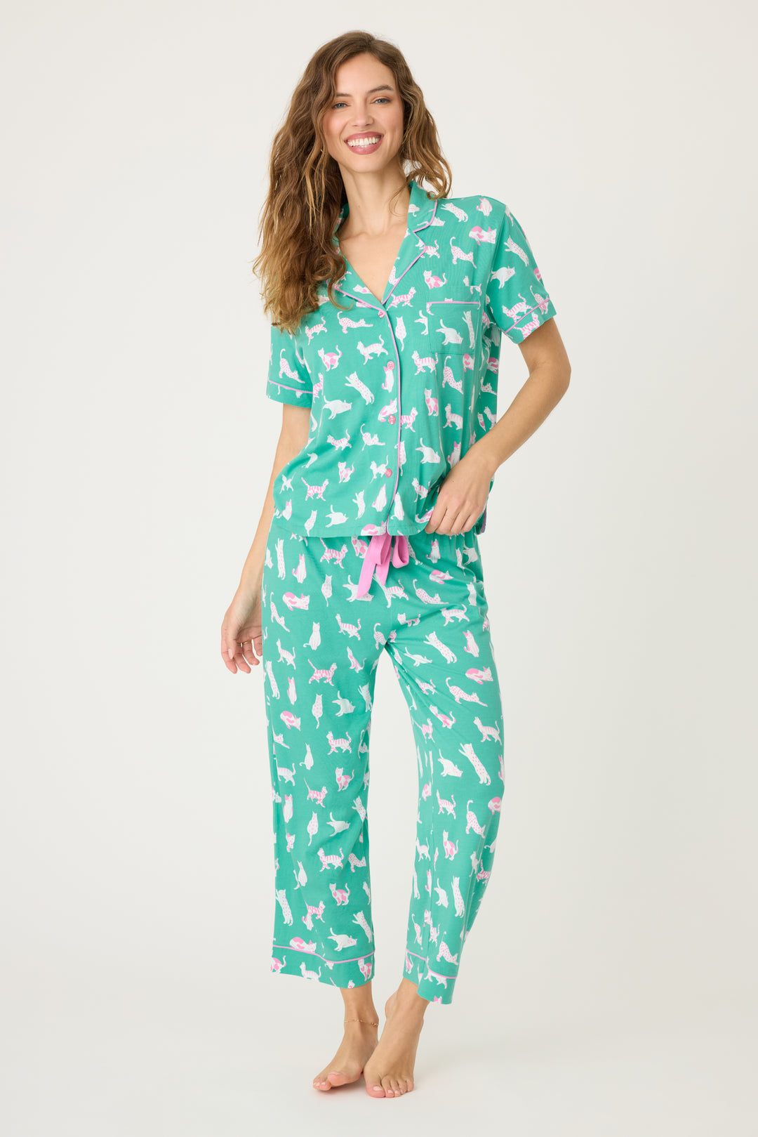 Women's breathable cotton-modal jersey short sleeve pajama set in teal with cats print. With pink contrast piping & tie. Button-front top & open leg pant.