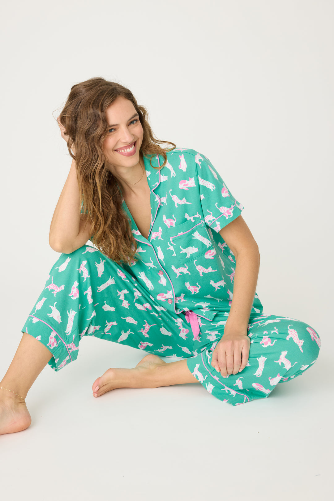 Women's breathable cotton-modal jersey short sleeve pajama set in teal with cats print. With pink contrast piping & tie. Button-front top & open leg pant.