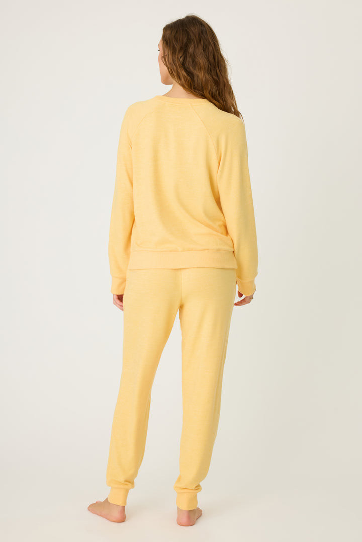 Women's sun yellow lounge set top & jogger with small floral embroidery on cuff.