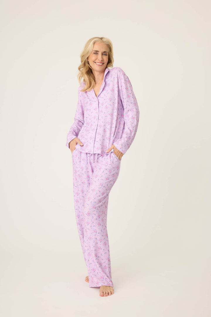 Women's classic pajama set with button-front notch collar top & tie waist pant.  Peachy jersey with lilac mini floral print.