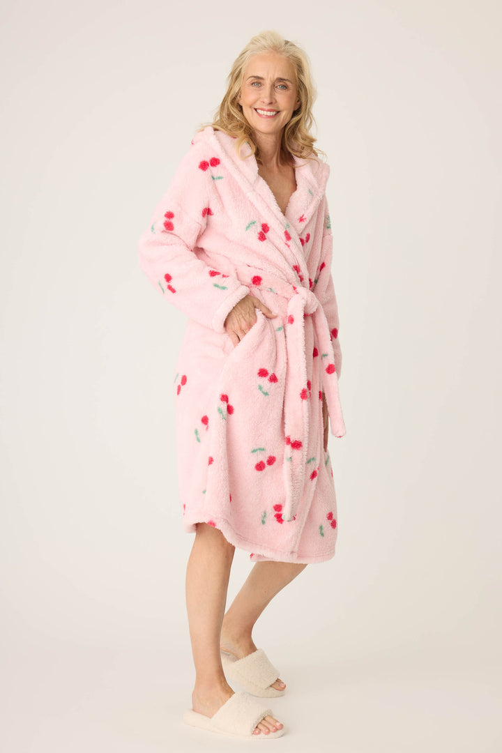 Women's pale pink plush robe with cherry pattern.