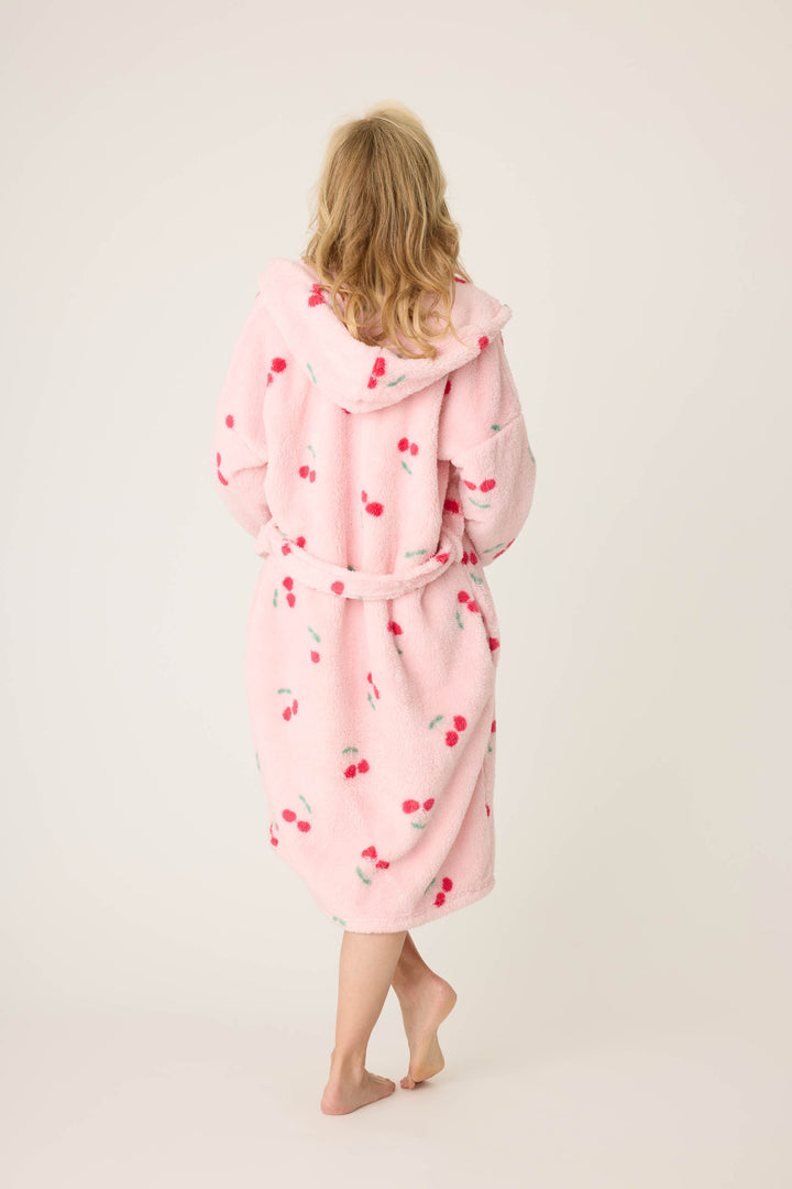 Women's pale pink plush robe with cherry pattern.