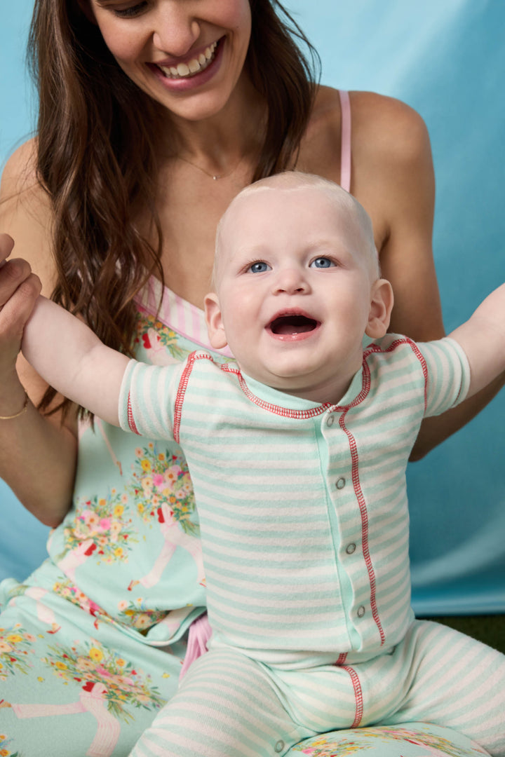 Gender-neutral infant onesie in mint-ivory stripes with snap front & contrast red stitching.