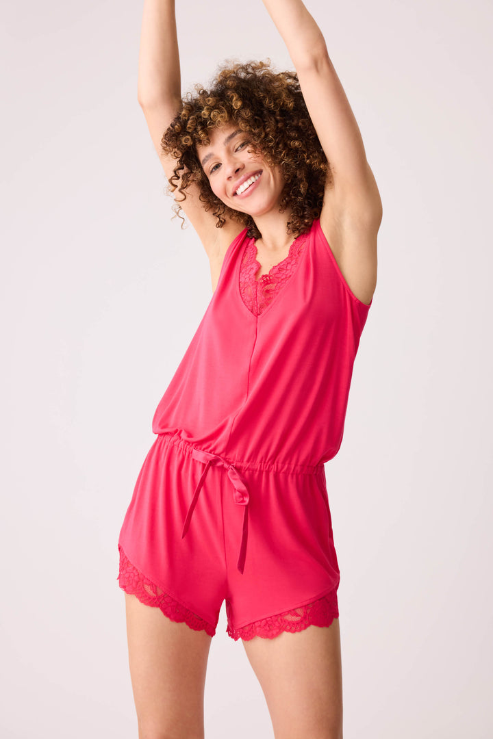 Women's hot pink romper with lace detail on front and back.