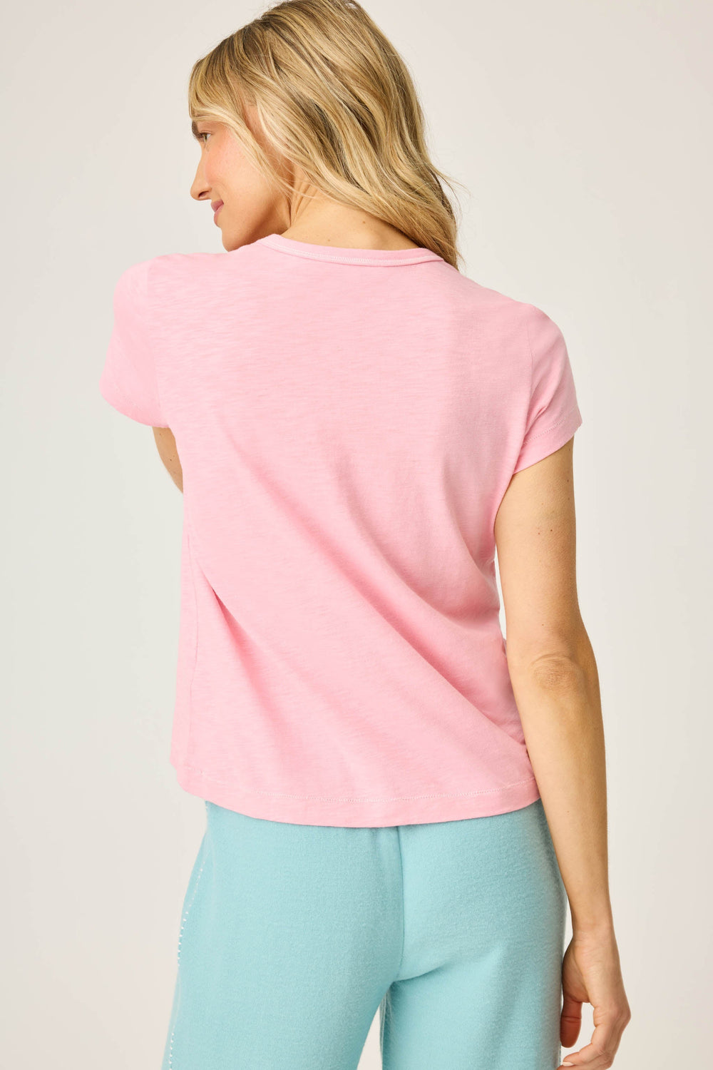 Women's pink short sleeve t-shirt with ALOHA floral graphic print.