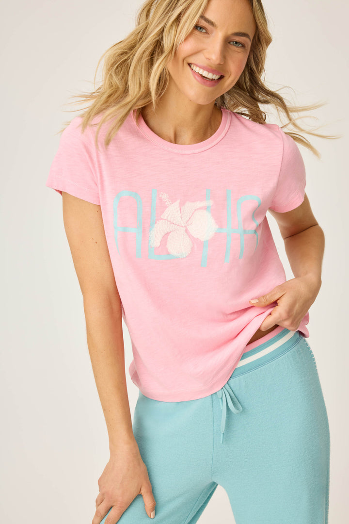 Women's pink short sleeve t-shirt with ALOHA floral graphic print.