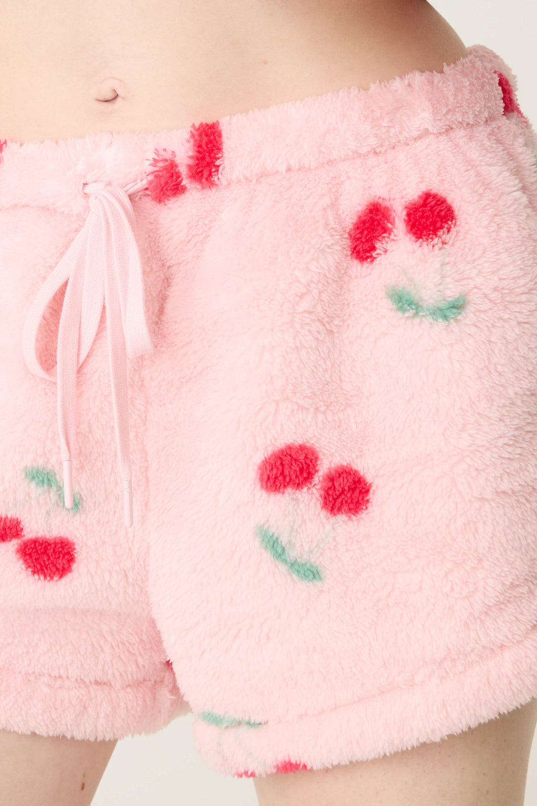 Women's pink fuzzy faux fur pj short with cherry pattern.