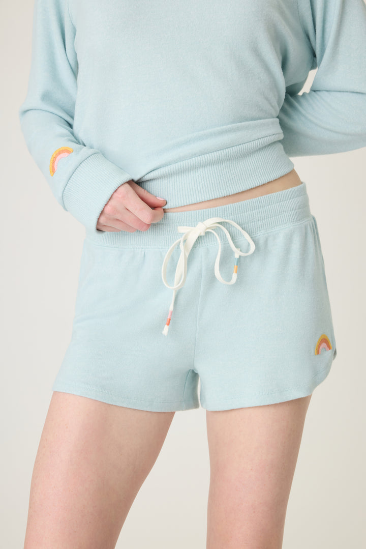 Women's blue melange lounge short with small rainbow embroidery on cuff.