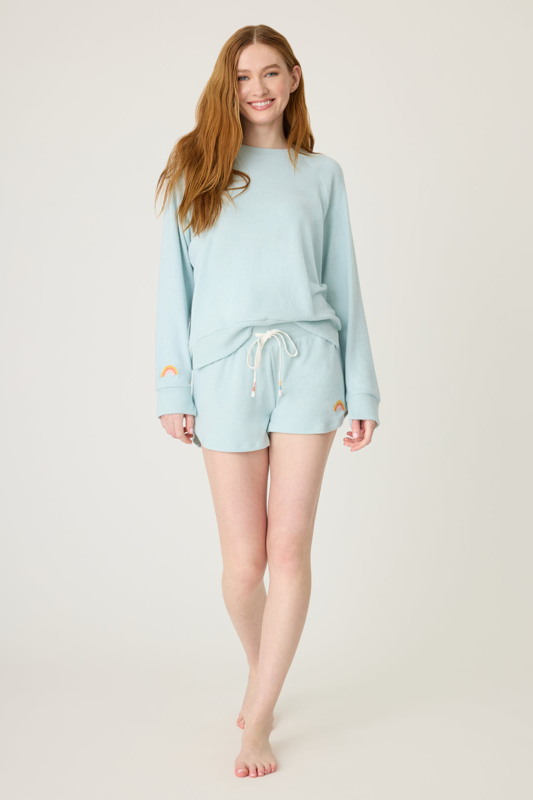 Women's blue melange lounge short with small rainbow embroidery on cuff.