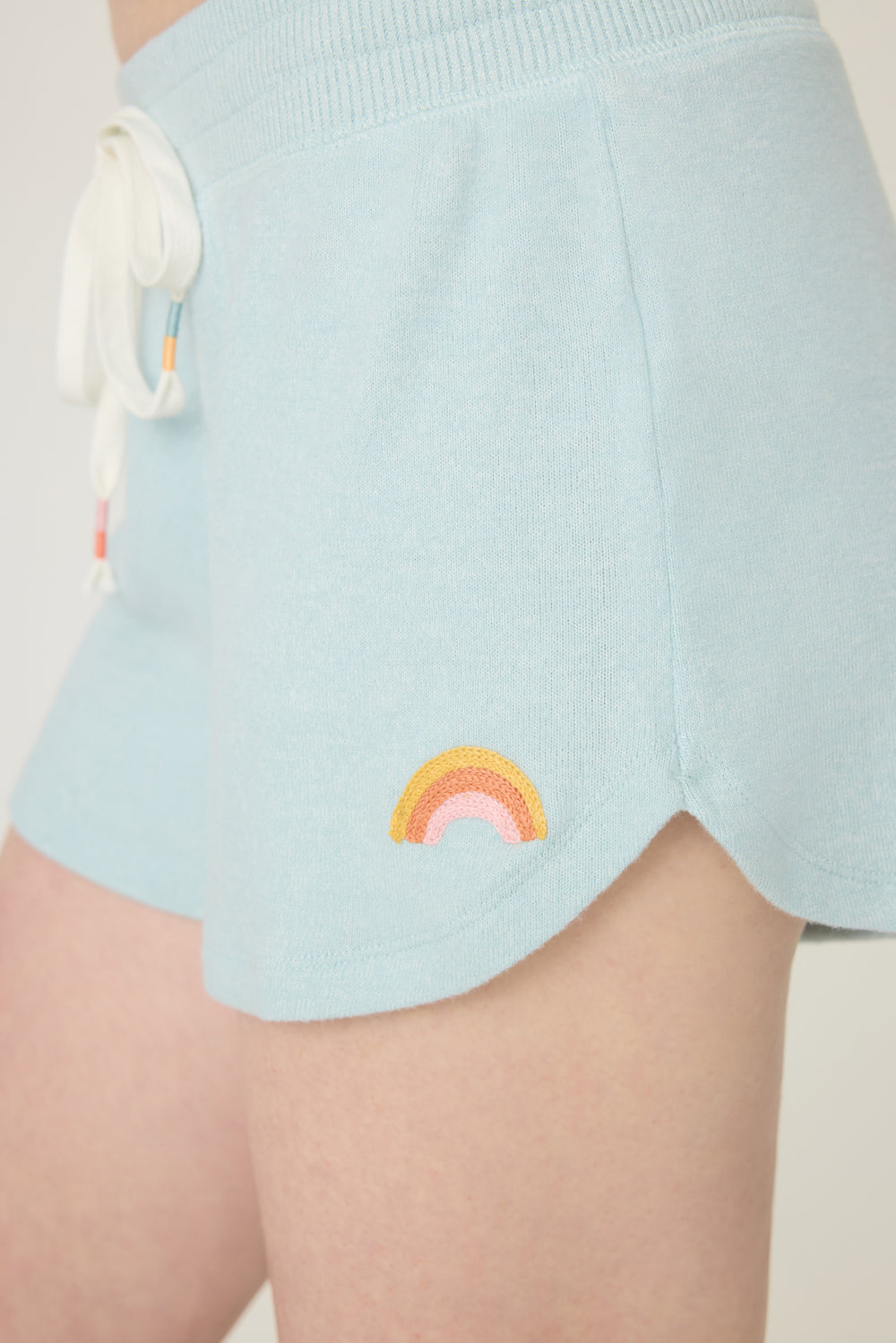Women's blue melange lounge short with small rainbow embroidery on cuff.