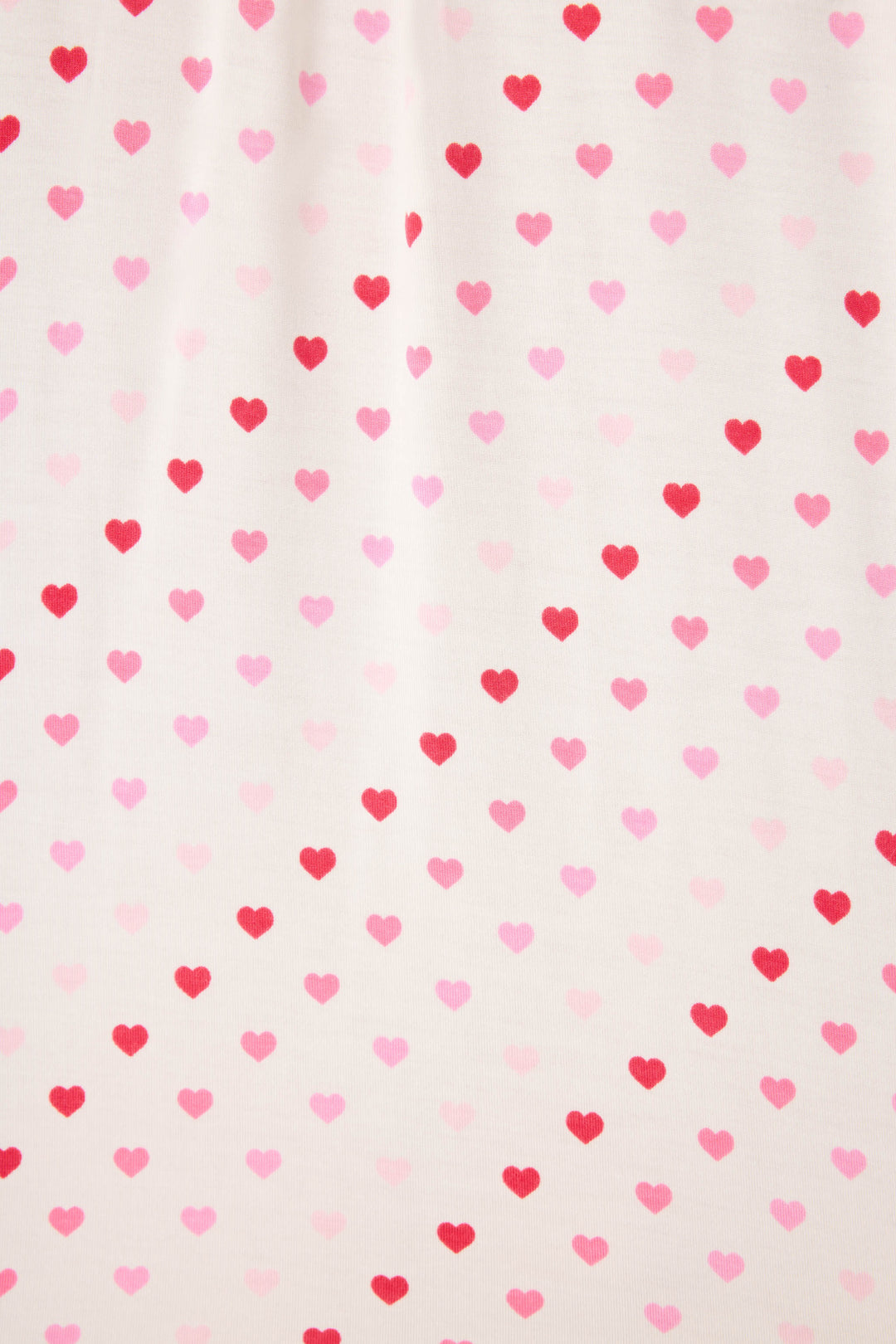 Women's white pj shorts with pink heart pattern and lace detail.