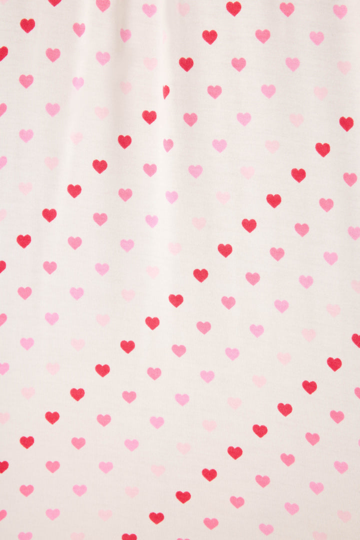 Women's white pj shorts with pink heart pattern and lace detail.