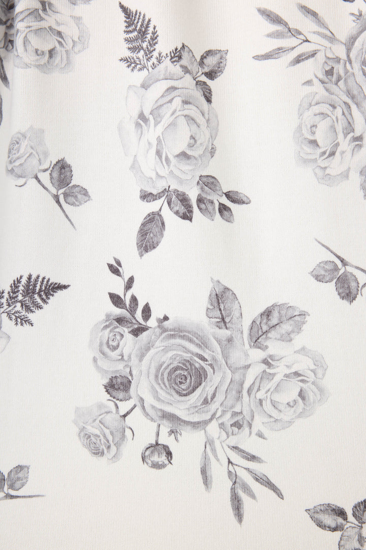 Women's white pj short with black rose pattern.