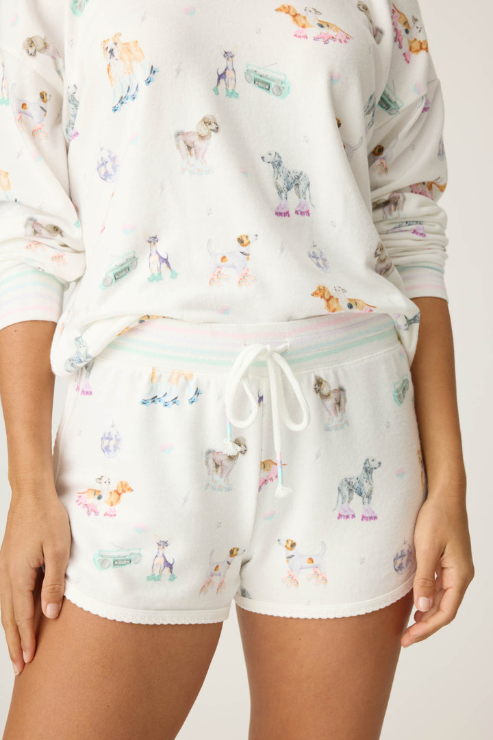 Women's ivory pajama short with dogs on rollerskates pattern. Relaxed fit with tie waist.