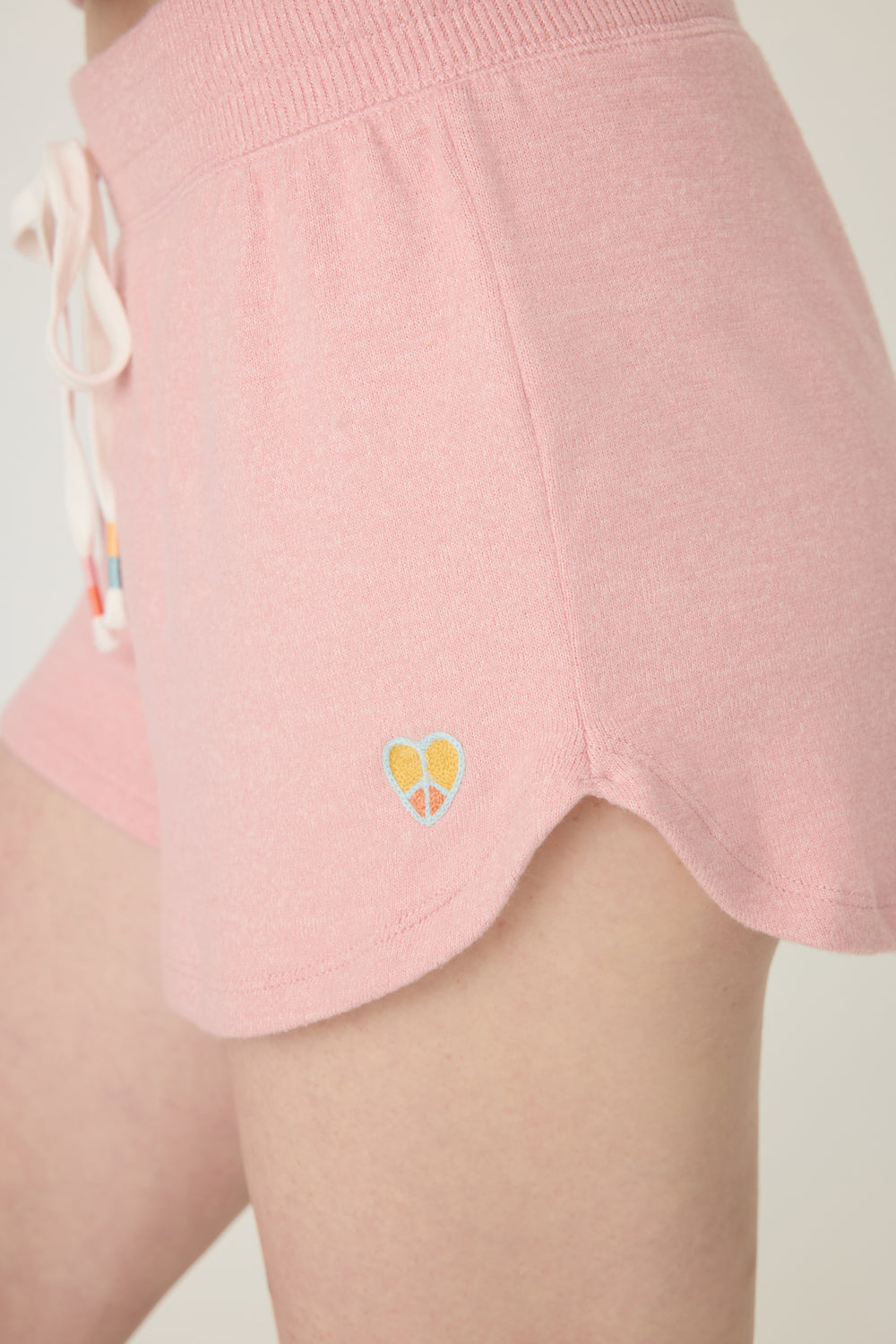 Women's pink melange lounge short with small heart embroidery on cuff.