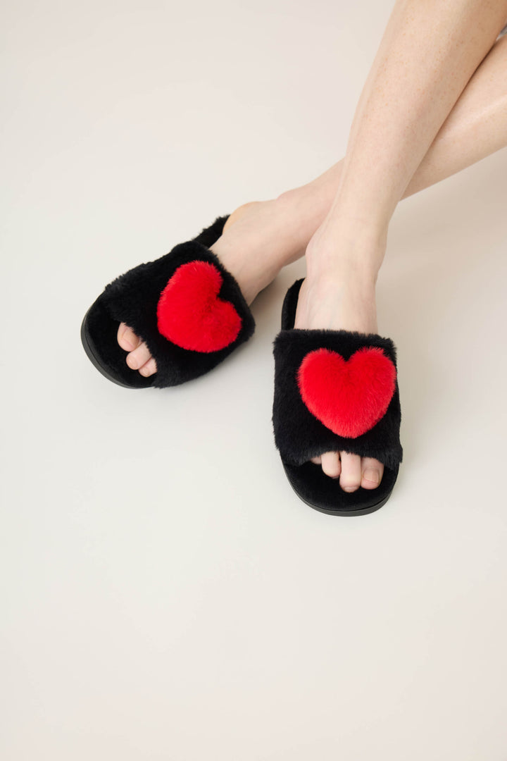 Women's black slippers with red heart.