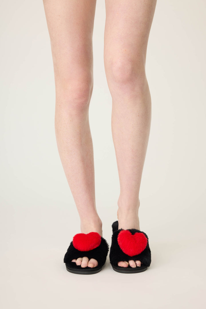 Women's black slippers with red heart.