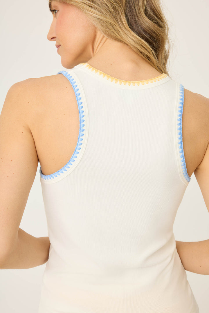 Women's ivory rib tank top with blue & yellow sharktooth embroidered stitch at armholes. Mini embroidered blue palm tree.