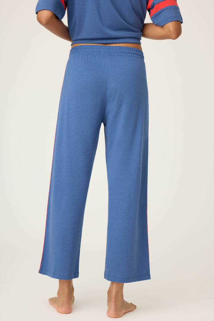 Women's navy crop lounge pant. Red side stripes & drawcord detail. Elastic & tie waist.