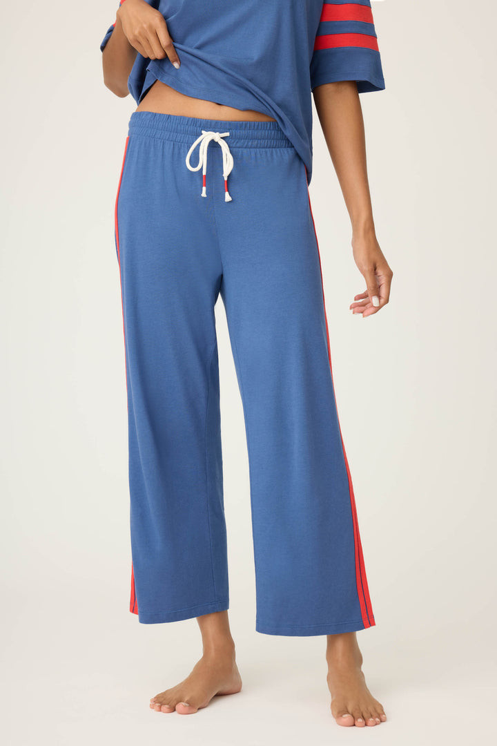Women's navy crop lounge pant. Red side stripes & drawcord detail. Elastic & tie waist.