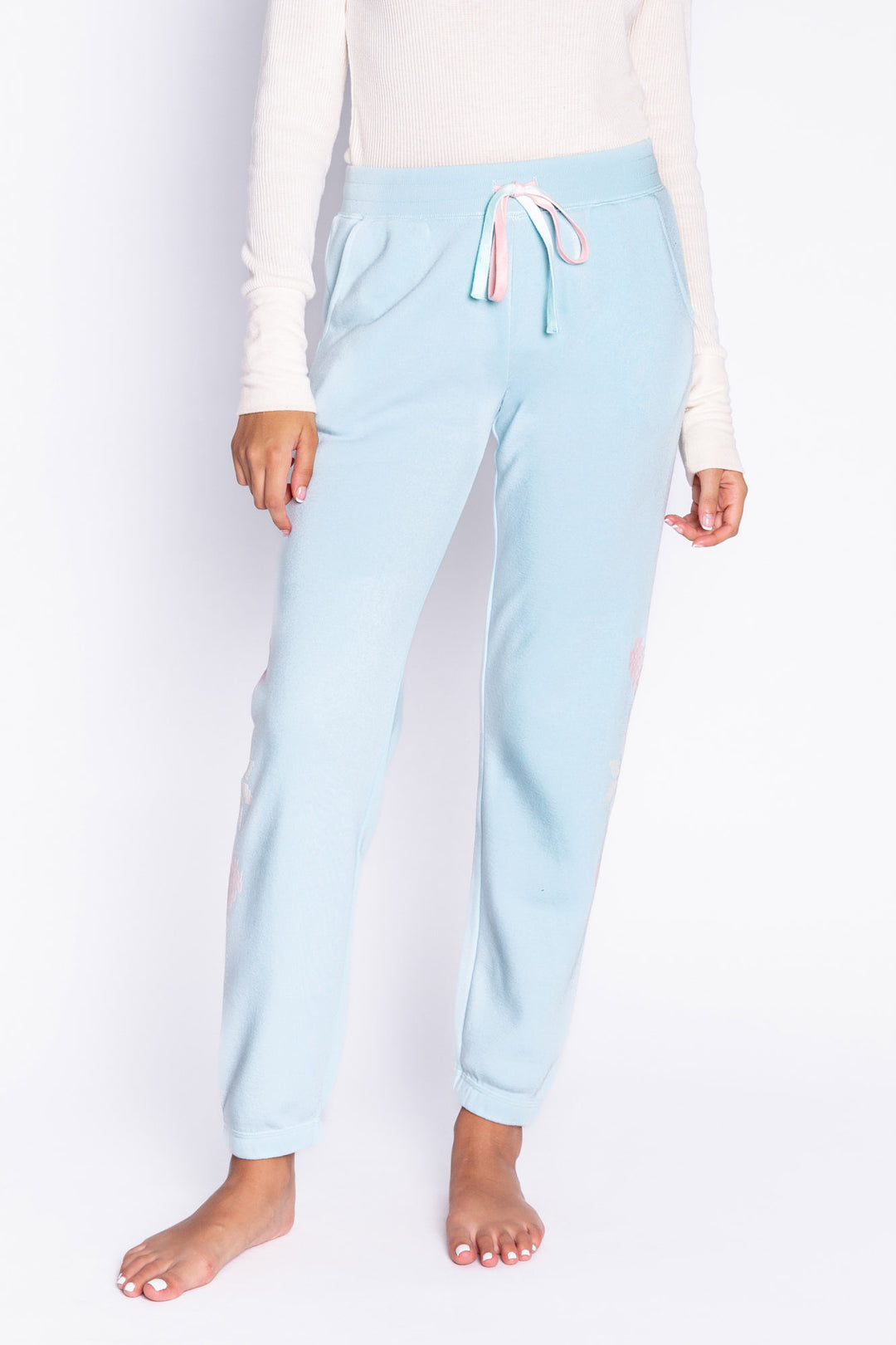 Light blue fleece jogger pant with flocked snowflake graphic print on sides. Comfy side pockets & tie waist. (6982901137508)