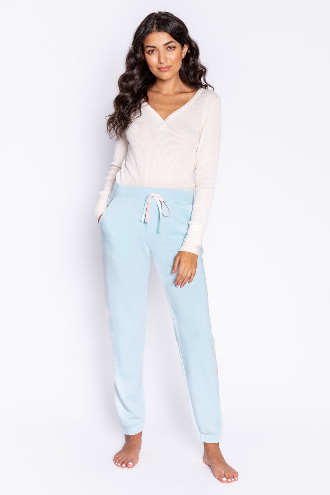 Light blue fleece jogger pant with flocked snowflake graphic print on sides. Comfy side pockets & tie waist. (6982901137508)