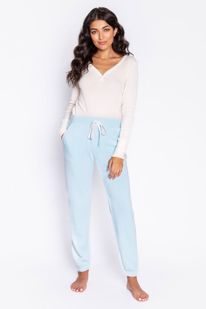 Light blue fleece jogger pant with flocked snowflake graphic print on sides. Comfy side pockets & tie waist. (6982901137508)