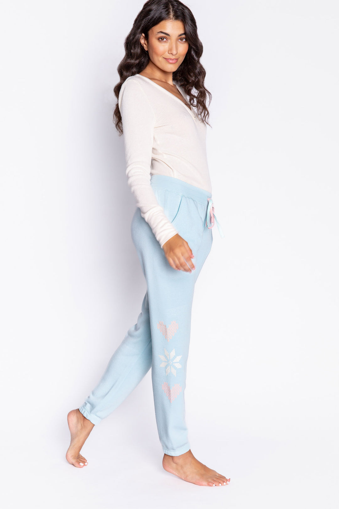 Light blue fleece jogger pant with flocked snowflake graphic print on sides. Comfy side pockets & tie waist. (6982901137508)