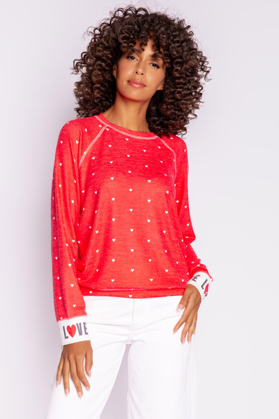 Bright red pullover top with mini hearts print. Contrast rib cuffs in ivory with LOVED lettering. Banded hem. (7068570452068)