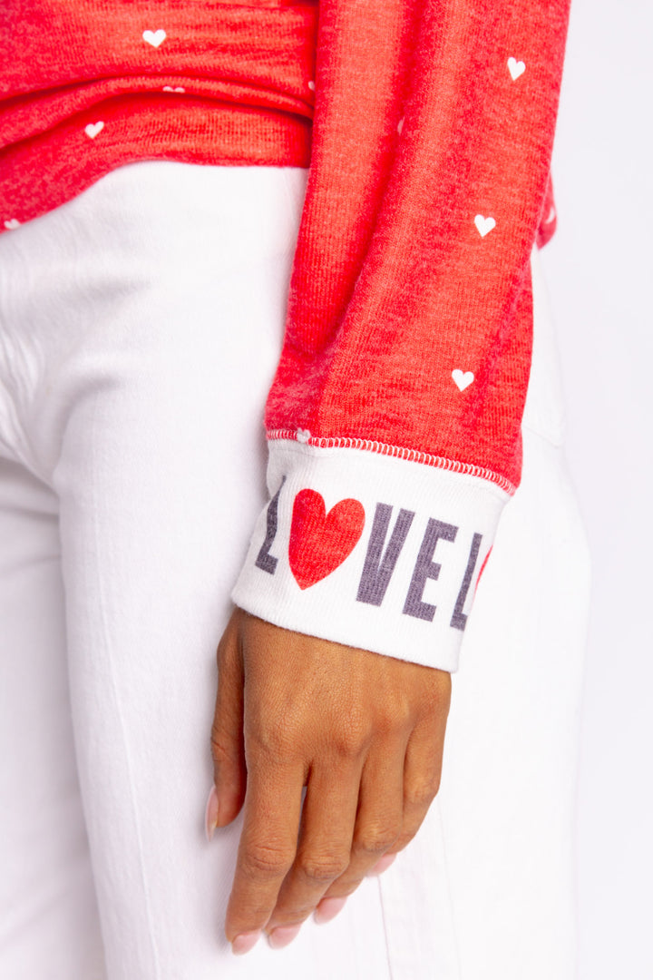 Bright red pullover top with mini hearts print. Contrast rib cuffs in ivory with LOVED lettering. Banded hem. (7068570452068)