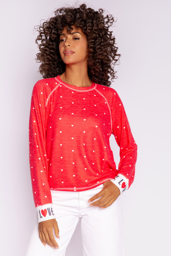 Bright red pullover top with mini hearts print. Contrast rib cuffs in ivory with LOVED lettering. Banded hem. (7068570452068)